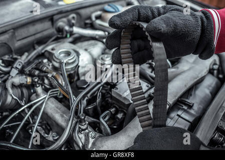 Replacing the belt. Car repair. Under the hood of the car. Toned photo. Stock Photo