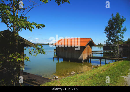 Boat Shed In The Water On The Shore Of Lake Kochel In Bavaria Stock Photo