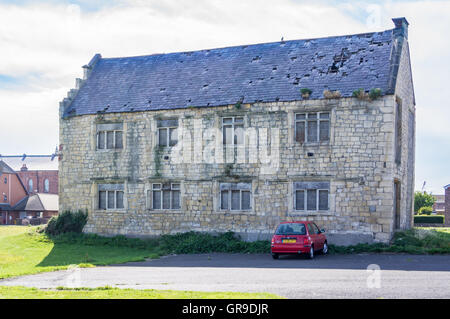 A Nissan Micra parked outside derelict Friarage manor house, 1605, The Headland, Hartlepool, County Durham, England Stock Photo