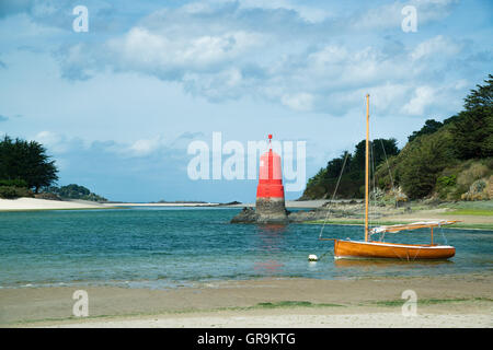 Sailboat In Picturesque Harbor Entrance, Brittany France Stock Photo