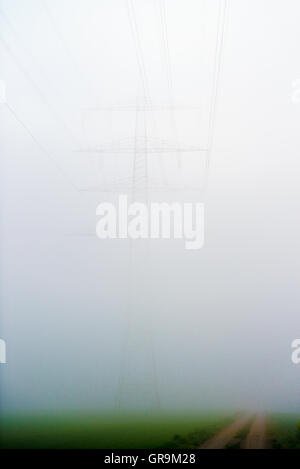 Power Pole Almost From The Fog Concealed Stock Photo