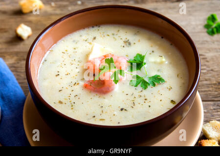 Vegetable spicy cream soup with shrimps in bowl close up Stock Photo