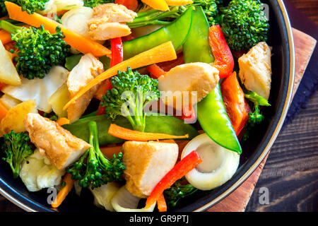 Healthy stir fried vegetables with chicken on pan close up Stock Photo