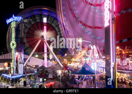 Amusement Park rides at night time in motion. Stock Photo
