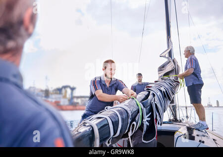 Men preparing sailing equipment Stock Photo