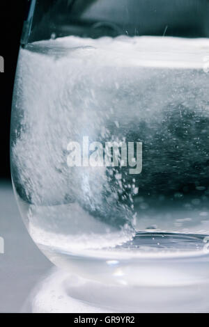 Effervescent Tablet In Water Glass Stock Photo