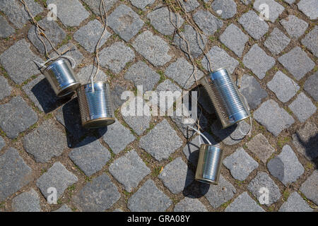 Tin Cans Bound To A Car On Cobbles At A Wedding Stock Photo