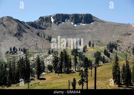 Hiking at Squaw Valley Ski Resort at Olympic Valley, California in the summer. View of the granite Palisades cliffs. Stock Photo