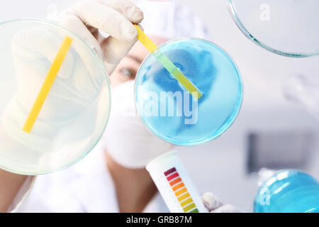 Chemist in the lab examines a sample of contaminated water Stock Photo