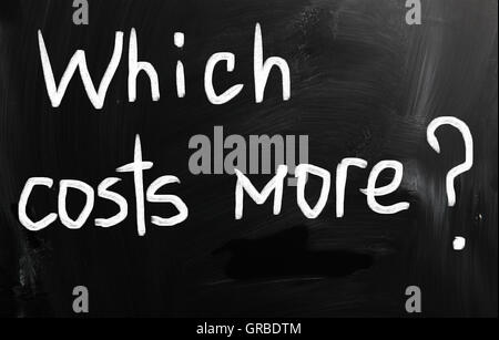 Which costs more? handwritten with white chalk on a blackboard Stock Photo