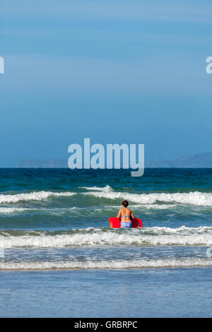 Body boarding on Druidstone Beach in Pembrokeshire Stock Photo