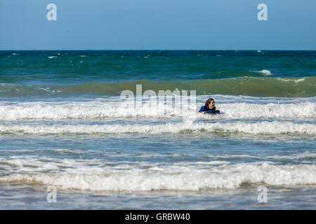 Body boarding on Druidstone Beach in Pembrokeshire Stock Photo