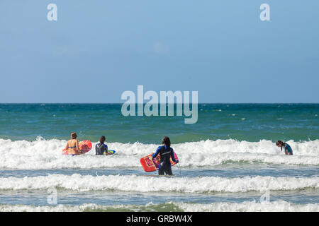 Body boarding on Druidstone Beach in Pembrokeshire Stock Photo