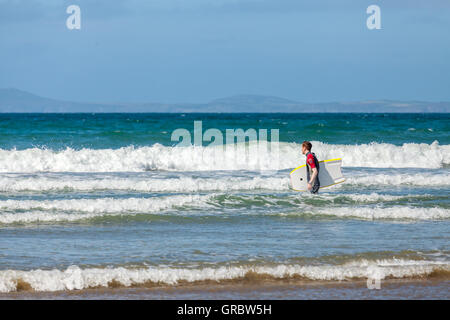 Body boarding on Druidstone Beach in Pembrokeshire Stock Photo