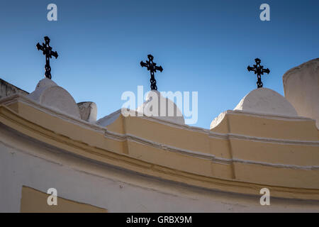 Three Christian Crosses On Church Roof Silhouetted Against The Blue Sky Stock Photo