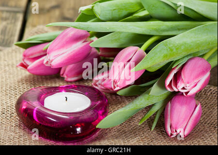 Purple Tulips On Old Wooden Table Stock Photo