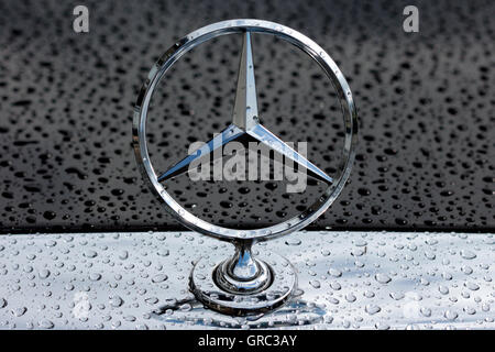 Mercedes Benz Star Logo On An Rainy Hood Stock Photo