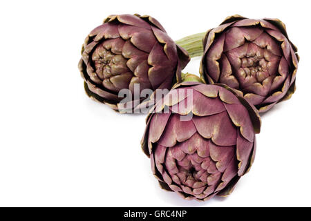 Three Fresh Artichokes Isolated On White Background Stock Photo