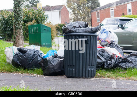 Piles of trash in black rubbish bags piled up on the pavement awaiting ...