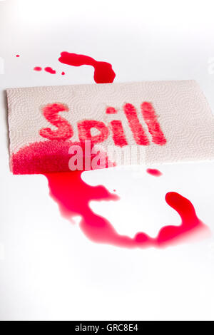 Red juice spill with word and paper towel on white surface Stock Photo