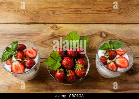 Layered strawberries diet yogurt dessert on wooden background. Summer dessert with fresh ripe strawberry. Stock Photo