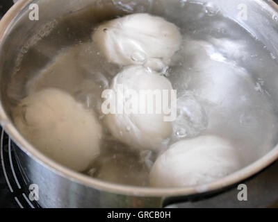 White Eggs Being Boiled In A Pot Stock Photo