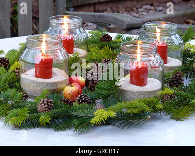 Decoration In Advent, Burning Red Candles, Fir Twigs And Apples, Cones Stock Photo