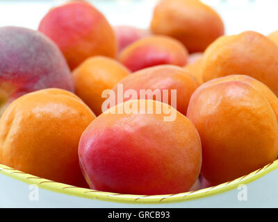 Some Apricots And One Peach On A Fruit Plate Stock Photo