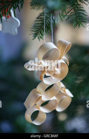 Christmas Tree Tag Made Of Splints Hanging At A Fir Twig Stock Photo