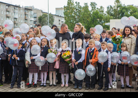 NOVOKUZNETSK, KEMEROVO REGION, RUSSIA - SEP, 1, 2016: Meeting with the first-grade pupils and teacher at schoolyard. The day of Stock Photo