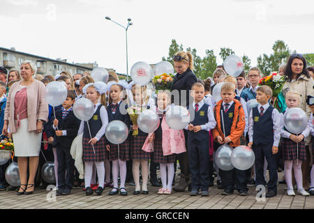 NOVOKUZNETSK, KEMEROVO REGION, RUSSIA - SEP, 1, 2016: Meeting with the first-grade pupils and teacher at schoolyard. The day of Stock Photo