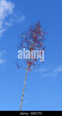 Maypole With Red Ribbons Under Blue Clouded Sky Stock Photo - Alamy