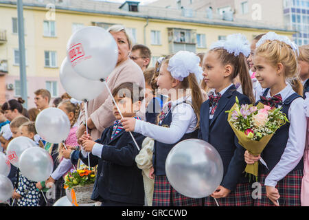 NOVOKUZNETSK, KEMEROVO REGION, RUSSIA - SEP, 1, 2016: Meeting with the first-grade pupils and teacher at schoolyard. The day of Stock Photo