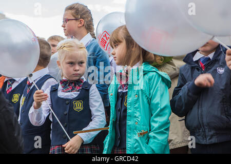 NOVOKUZNETSK, KEMEROVO REGION, RUSSIA - SEP, 1, 2016: Meeting with the first-grade pupils and teacher at schoolyard. The day of Stock Photo