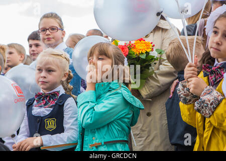 NOVOKUZNETSK, KEMEROVO REGION, RUSSIA - SEP, 1, 2016: Meeting with the first-grade pupils and teacher at schoolyard. The day of Stock Photo