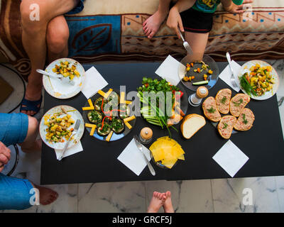 Top view of family party near a Table setting with a variety of side dishes Stock Photo