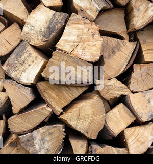 Background of dry chopped firewood logs in a pile Stock Photo