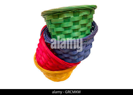 Colored wicker baskets one inside the other on a white background seen from above Stock Photo
