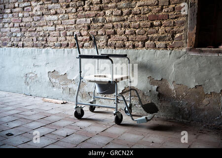 Old Toilet Stool In The Yard Of An Abandoned Nursing Home Stock Photo