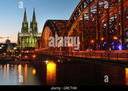 Cologne Cathedral With Railway Bridge At Dusk Stock Photo