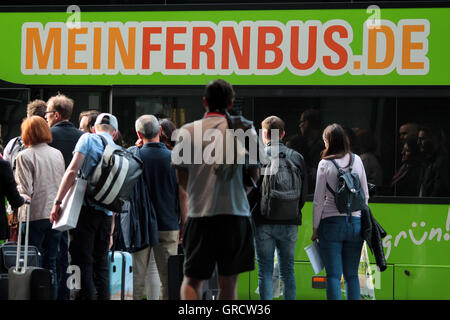 Long Distance Bus Meinfernbus With Silhouettes Of Waiting Travelers In Munich Stock Photo