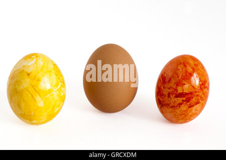 Two Easter Eggs With One Normal Egg In The Middle Stock Photo