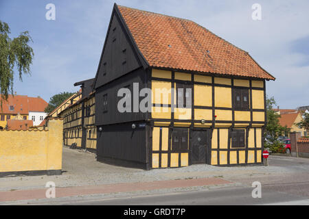 Yellow Painted Half-Timbered House On A Street Corner In Nakskov Denmark Stock Photo