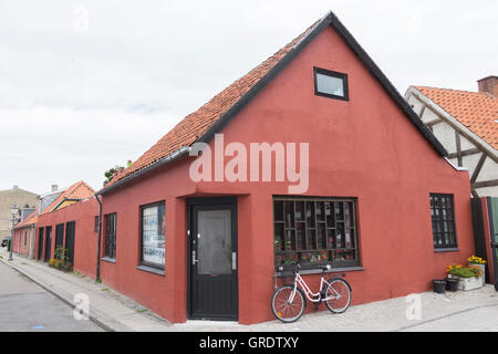 Red Corner House In Nykobing With A Small Shop And A Bike In Front Stock Photo