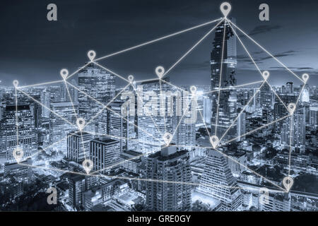 Bangkok night view in business district with map pin flat network above Bangkok city with network connection concept Stock Photo