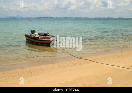 Old wooden fishing boat landing on the beach Stock Photo - Alamy