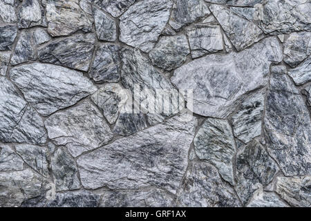 Abstract background - masonry from gray-blue stones close-up Stock Photo