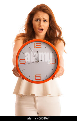 Woman showing a clock as a sign of being late isolated over white Stock Photo