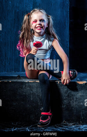 The funny crasy girl with candy on dark background Stock Photo