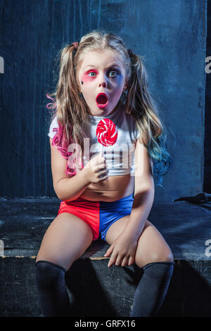 The funny crasy girl with candy on dark background Stock Photo